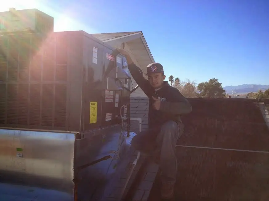 HVAC technician performing Boiler Repair on a rooftop unit in Kimberly